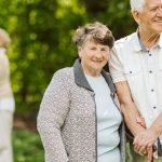 Elder people with the caregiver in the garden Elder people with the caregiver in the garden